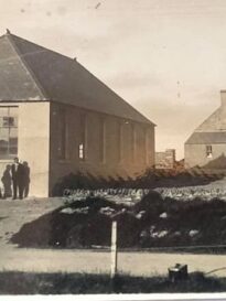 Photo showing the new 1932 school and the older 1867 school, North Walls, Orkney