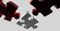 Three jigsaw pieces, two red one grey on a grey background